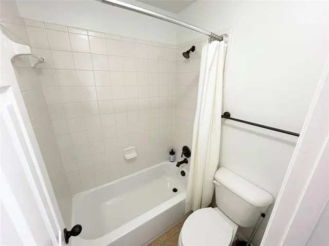 a bathroom with a toilet and a bathtub