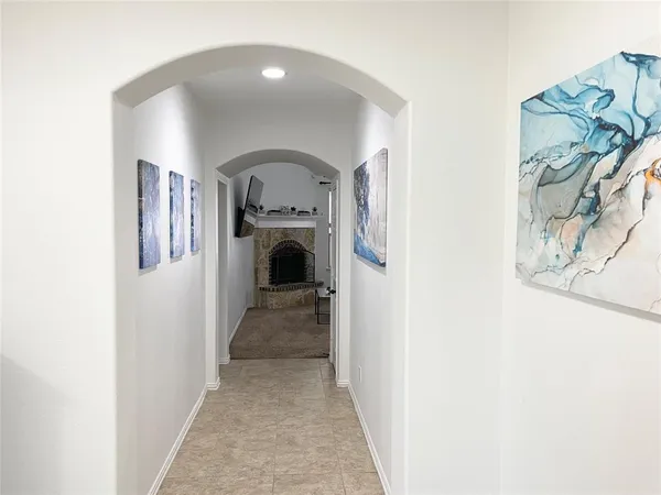 a view of staircase with wooden floor and white walls