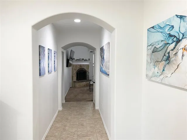 a view of staircase with wooden floor and white walls