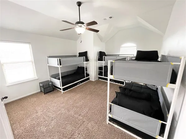 a living room with furniture and a ceiling fan