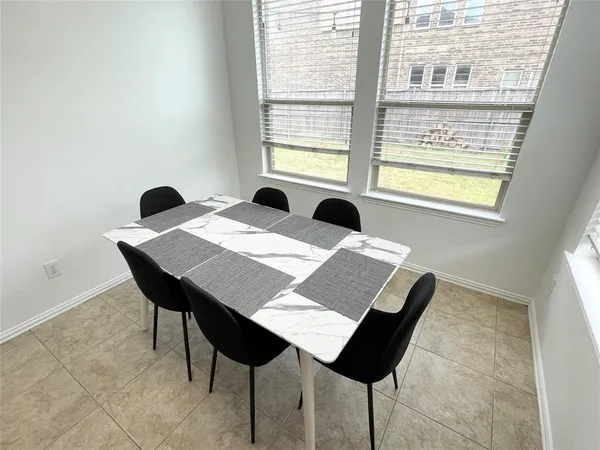a view of a dining table and chairs in a room