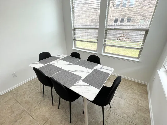 a view of a dining table and chairs in a room