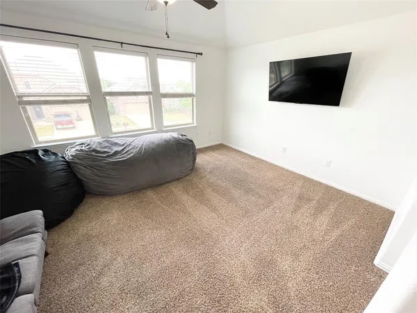 a living room with a flat screen tv and a window