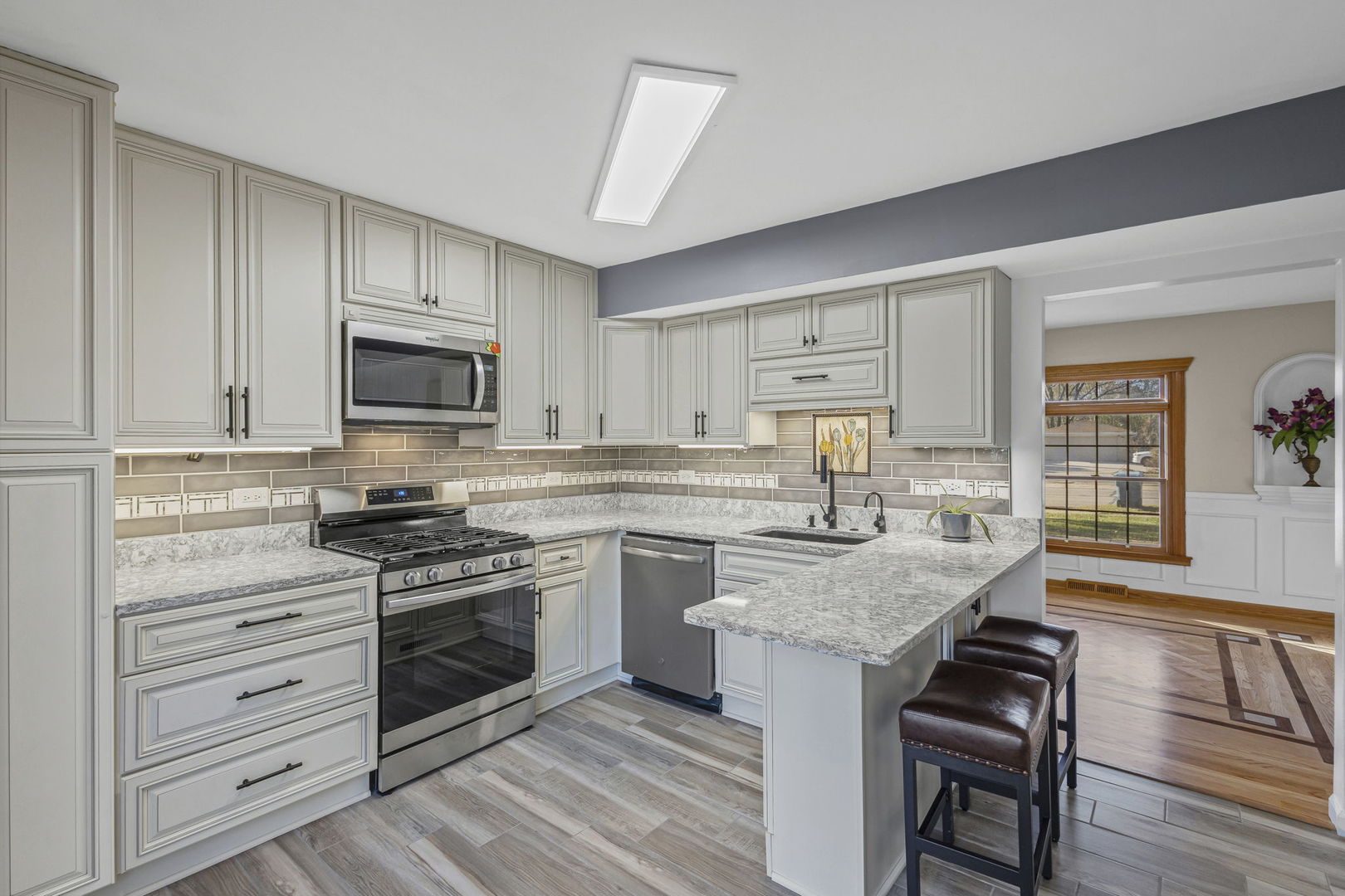 1323 South Roselle Road Schaumburg, IL 60193 - Photo 12 of 51 a kitchen with sink a stove and cabinets