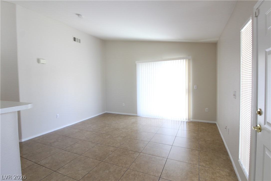1881 West Alexander Road, Unit 2041 North Las Vegas, NV 89032 - Photo 3 of 20 LIVING ROOM WITH DOOR LEADING TO BALCONY