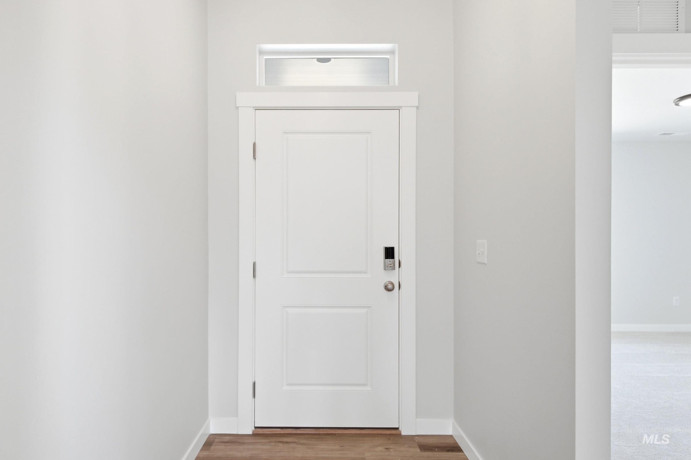 12817 Decatur Street Nampa, ID 83651 - Photo 2 of 19 White paneled door with transom window and electronic lock