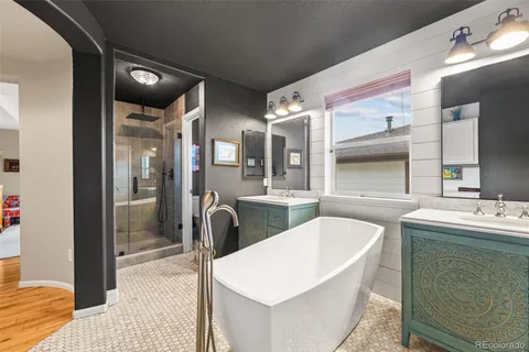 a large bathroom with a tub and shower