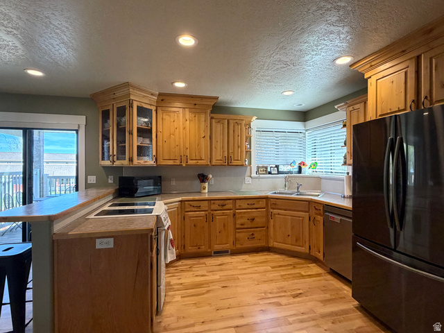 202 375 West Providence, UT 84332 - Photo 10 of 61 Kitchen featuring plenty of cupboards, a peninsula, a textured ceiling, a kitchen breakfast bar, and recessed lighting