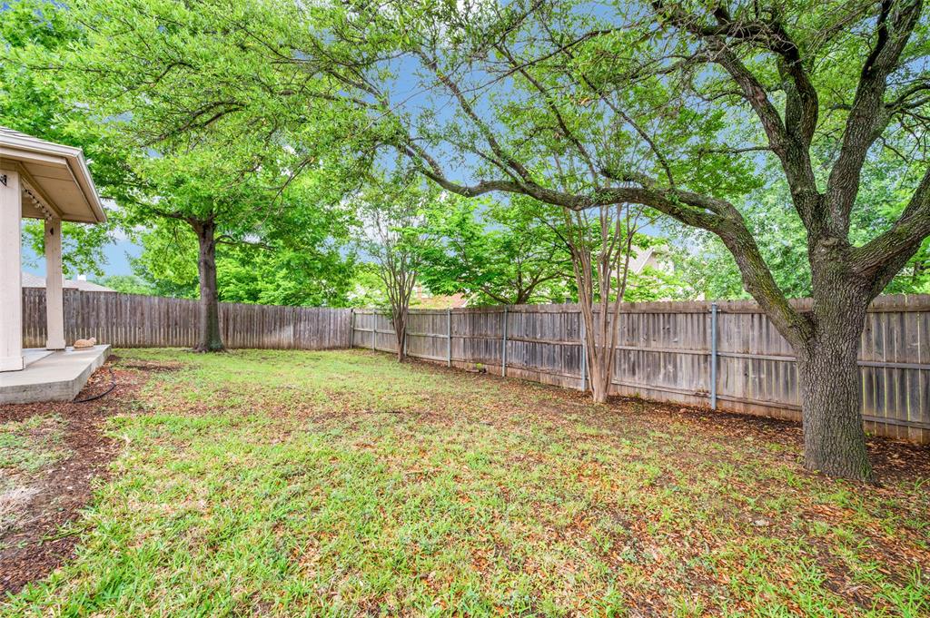 7306 Vista Ridge Lane Sachse, TX 75048 - Photo 21 of 23 a view of a backyard with a small cabin and a large tree