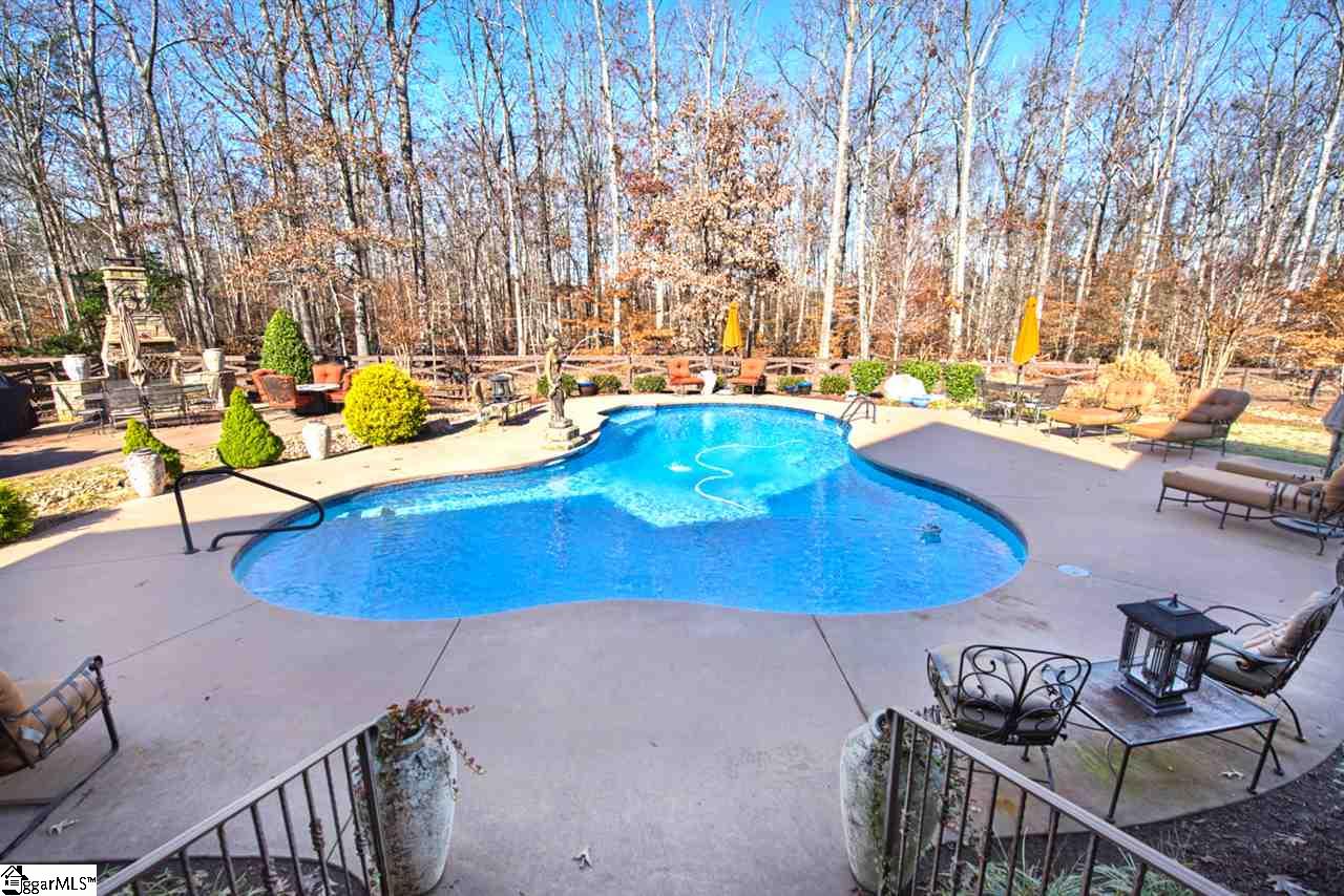 211 New Castle Drive Duncan, SC 29334 - Photo 4 of 36 Great space for entertaining with comfortable padded flooring in pool, large pool deck, rock fireplace, outdoor grilling station, covered patio with TV and outdoor music throughout backyard. Multiple lighting styles capture the mood and view.