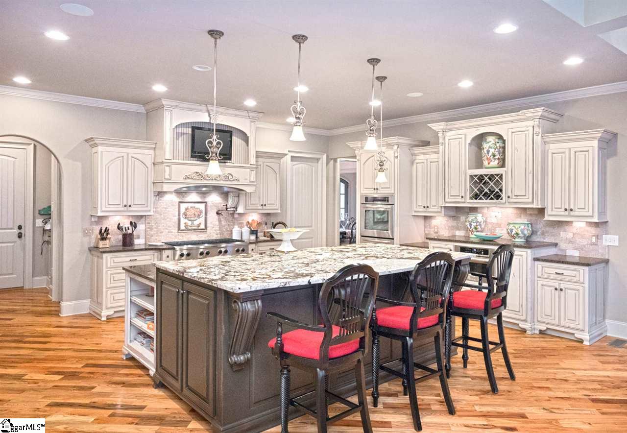 211 New Castle Drive Duncan, SC 29334 - Photo 6 of 36 and size! Every feature you have dreamed of! Professional grade Kitchenaid SS appliances, 8 BURNER gas cooktop w/ pot filler, vented hood oversized refrigerator, double ovens and ice machine. Custom cabinets w/ all the luxuries.