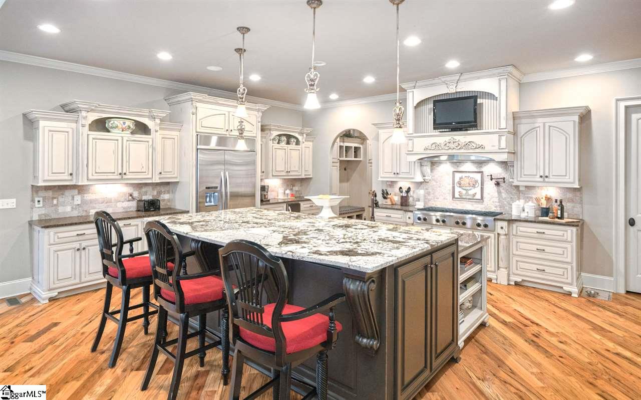 211 New Castle Drive Duncan, SC 29334 - Photo 7 of 36 Archway leads to the large walk in pantry and mudroom that are built with the same quality as the kitchen cabinets. Wonderful lighting and windows. immaculate. Central Vac throughout home.