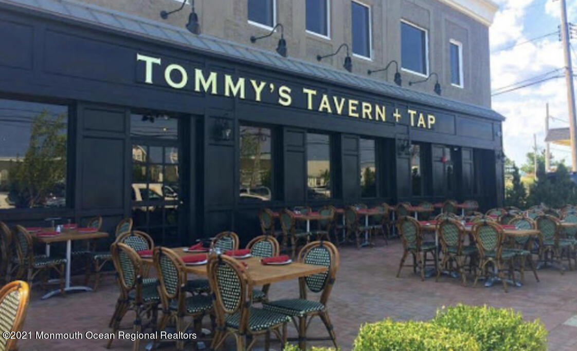 17 Via Ripa Way Sea Bright, NJ 07760 - Photo 28 of 33 a view of a cafe with a couple of people in a patio