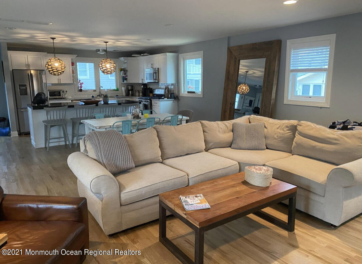 17 Via Ripa Way Sea Bright, NJ 07760 - Photo 4 of 33 a living room with furniture and a dining table with kitchen view