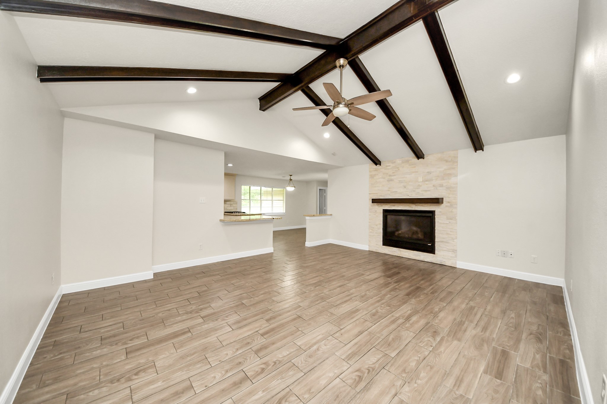 19435 Interstate 45 Spring, TX 77388 - Photo 18 of 24 a view of an empty room with wooden floor and a window