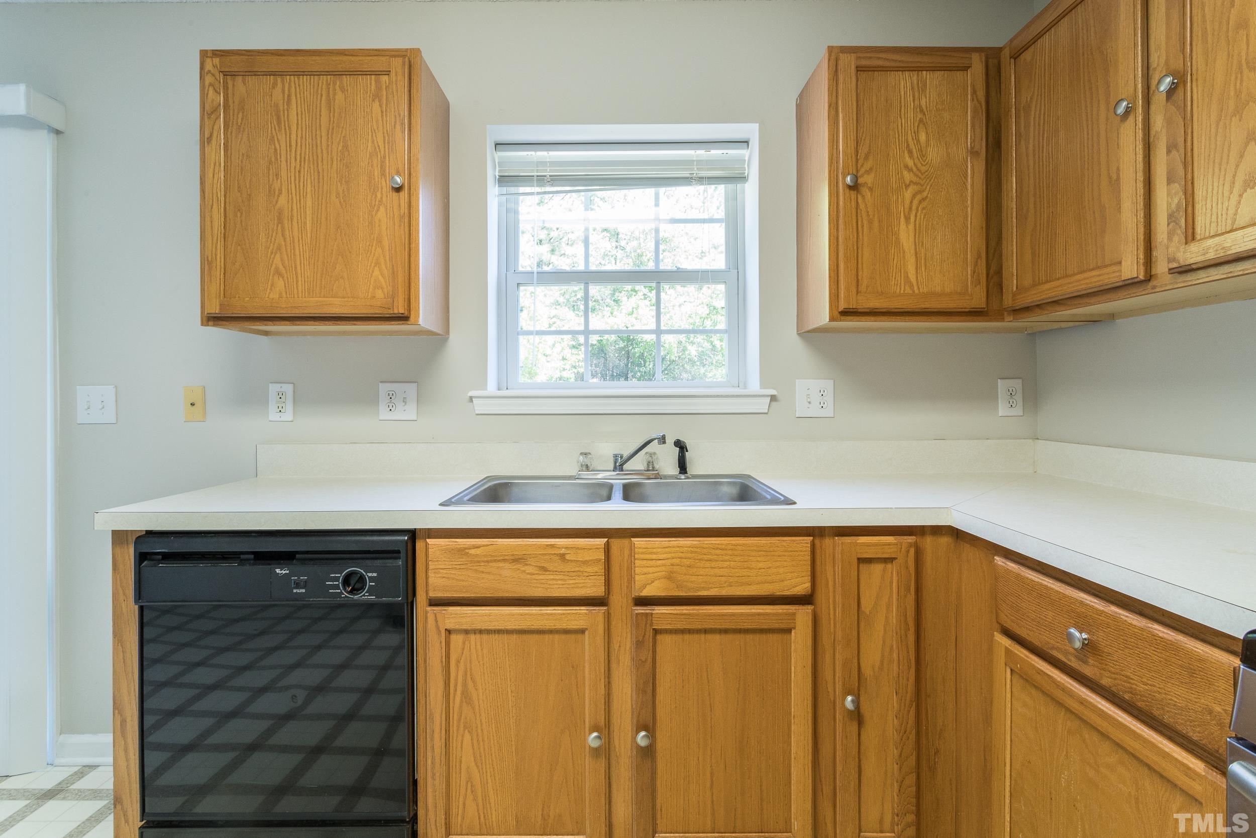 4411 Nightfall Court Durham, NC 27713 - Photo 14 of 28 a kitchen with stainless steel appliances granite countertop white cabinets sink and window