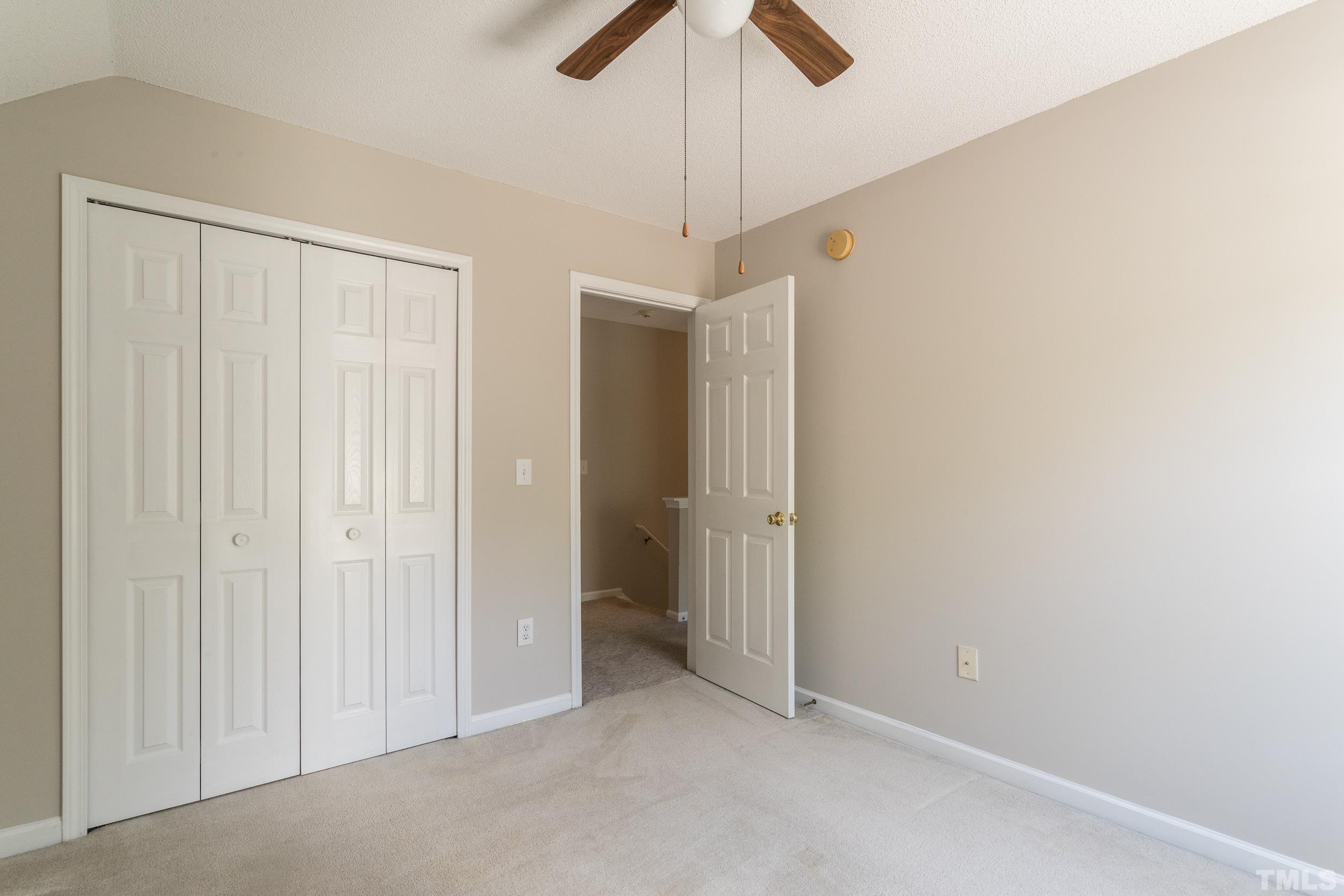 4411 Nightfall Court Durham, NC 27713 - Photo 17 of 28 a view of an empty room and chandelier fan