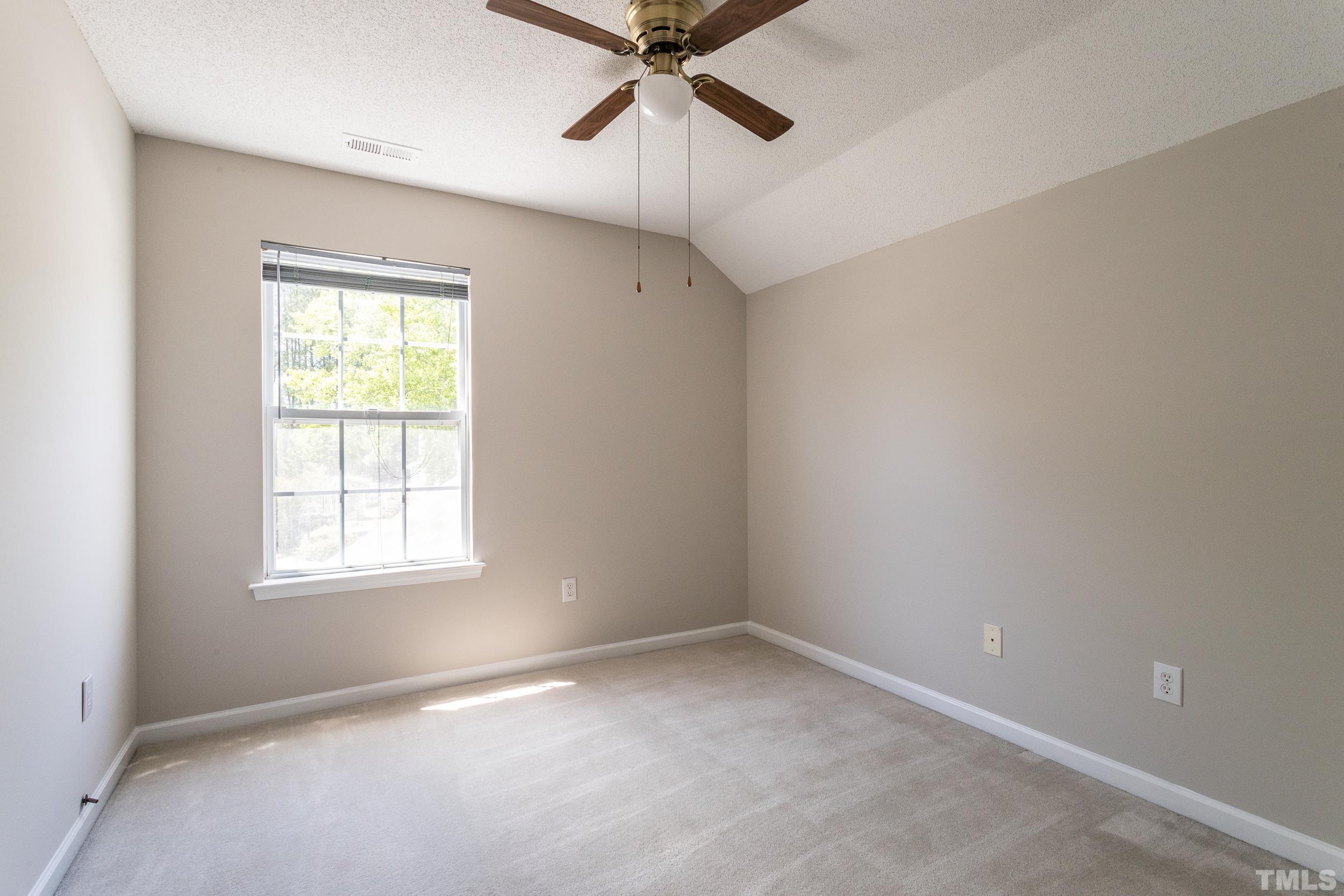 4411 Nightfall Court Durham, NC 27713 - Photo 20 of 28 an empty room with a window and a fan