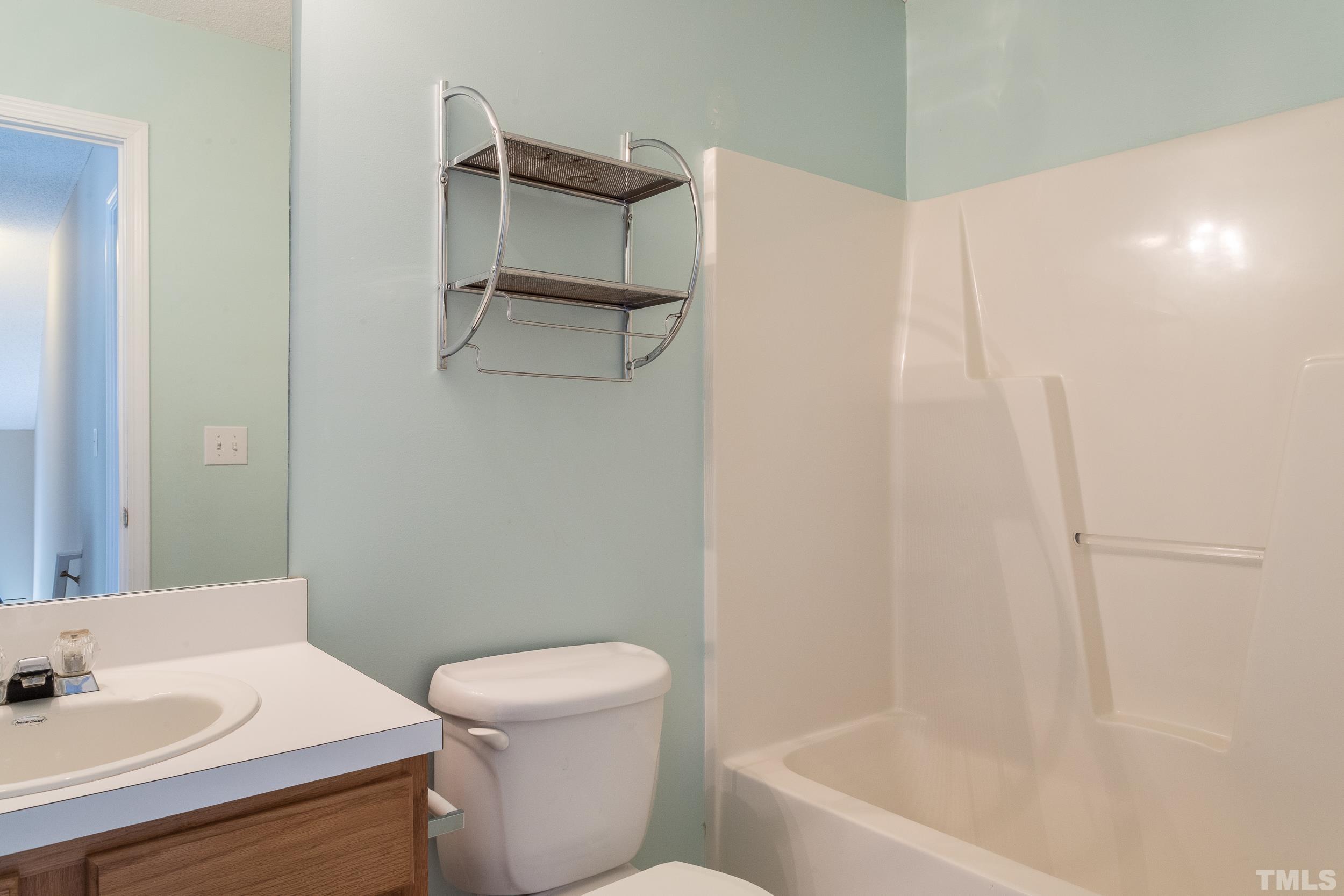 4411 Nightfall Court Durham, NC 27713 - Photo 21 of 28 a white toilet sitting next to a bath tub