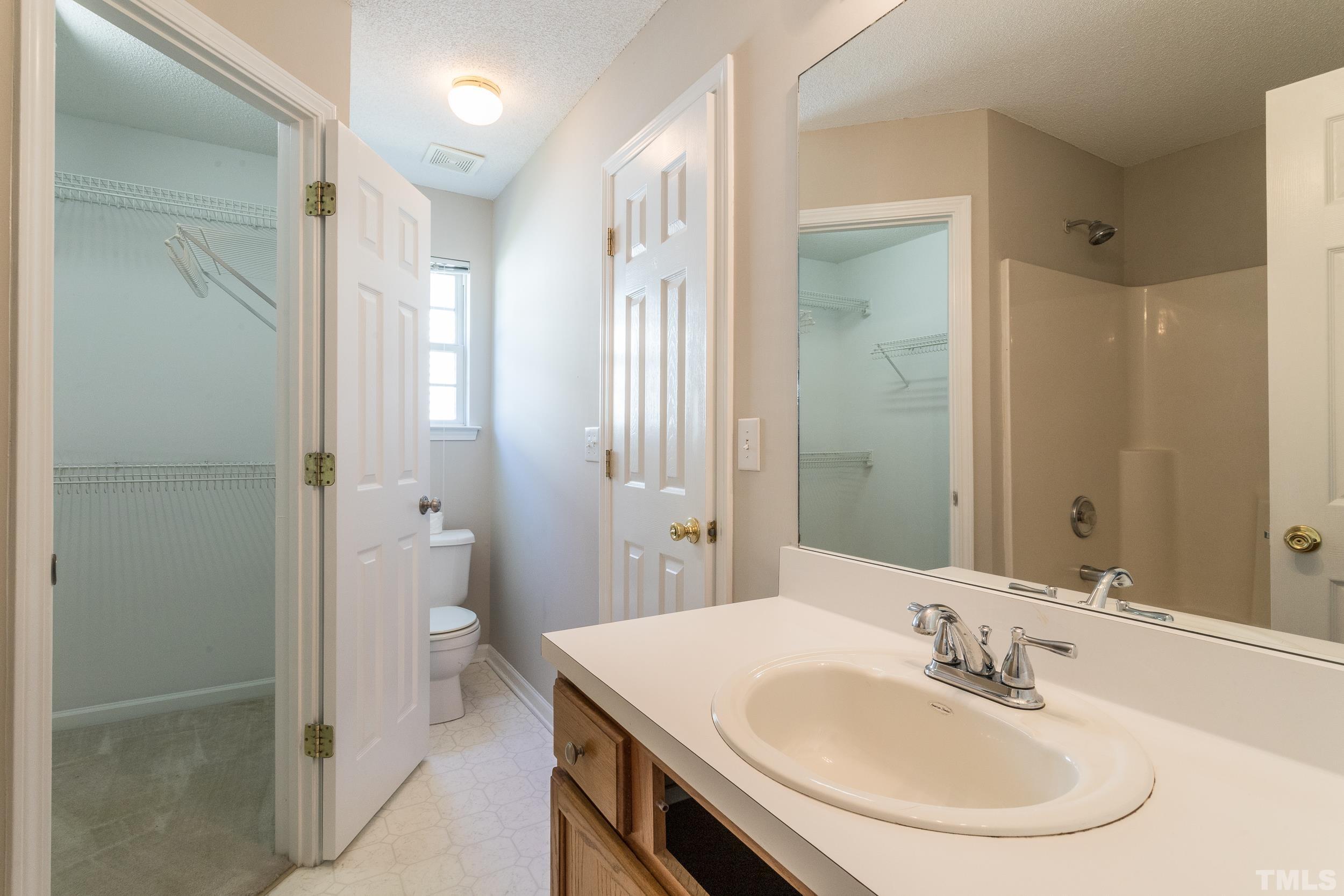 4411 Nightfall Court Durham, NC 27713 - Photo 22 of 28 a bathroom with a sink a toilet and shower