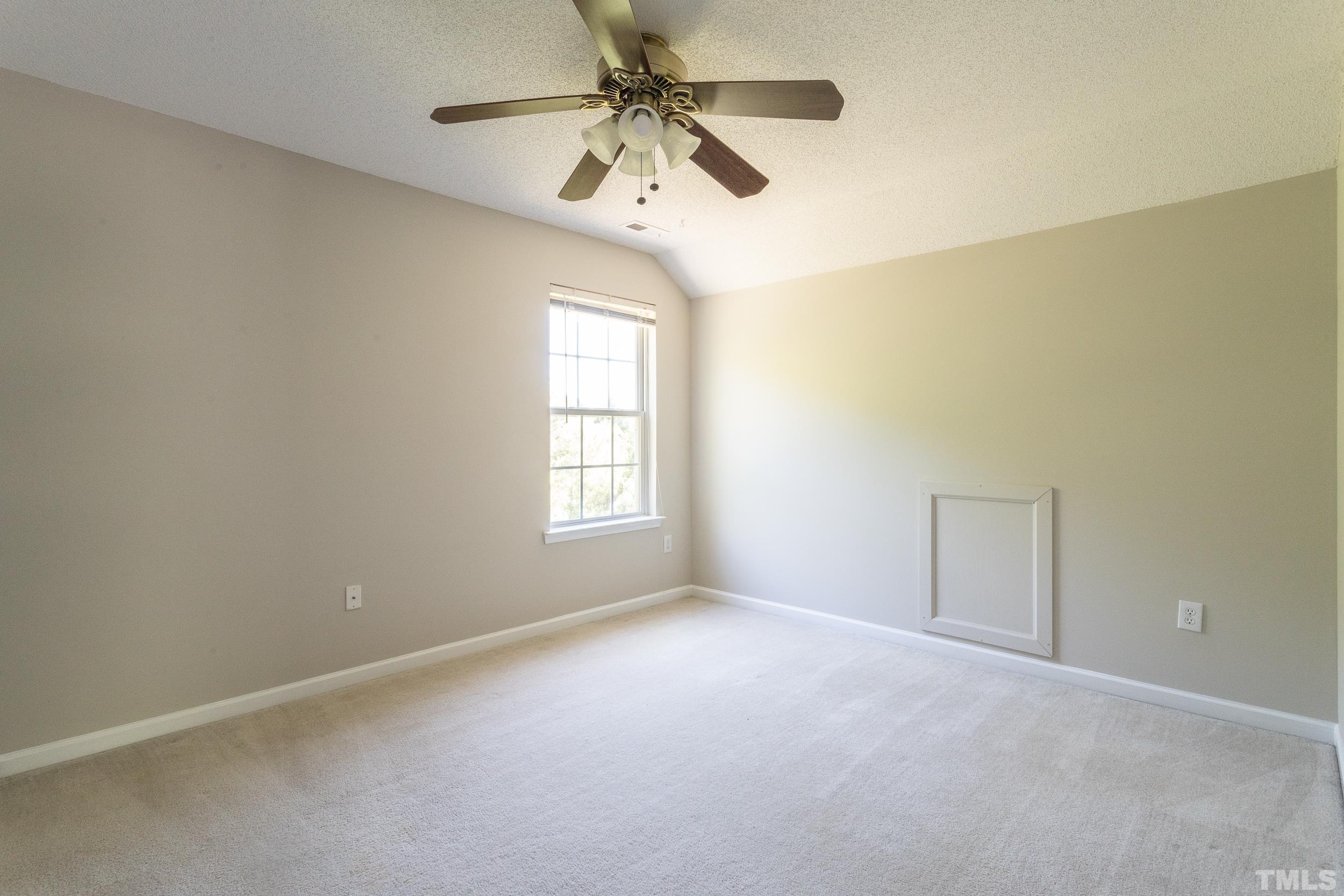 4411 Nightfall Court Durham, NC 27713 - Photo 24 of 28 an empty room with a window and a fan