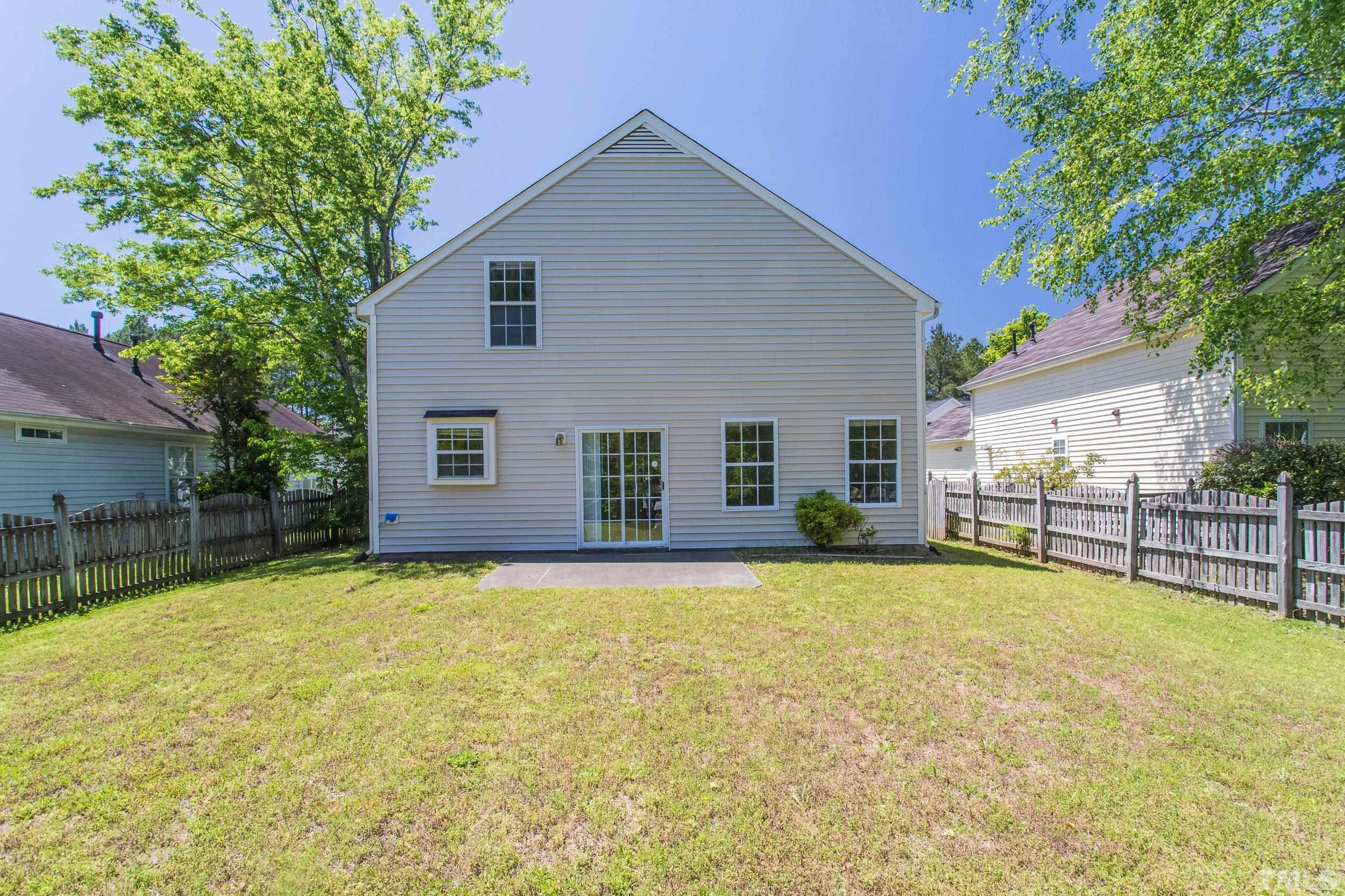 4411 Nightfall Court Durham, NC 27713 - Photo 25 of 28 a view of a house with a yard and a large tree