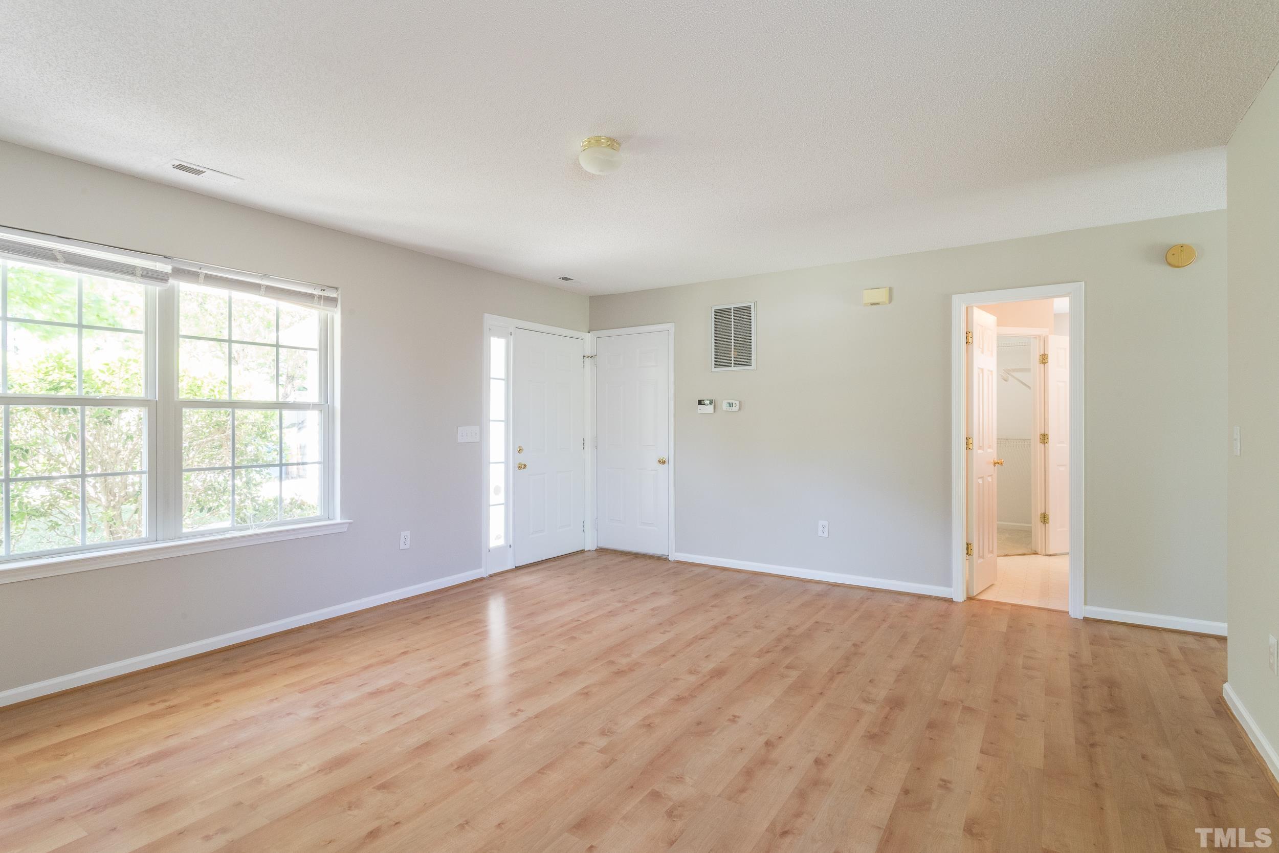 4411 Nightfall Court Durham, NC 27713 - Photo 3 of 28 an empty room with wooden floor and windows