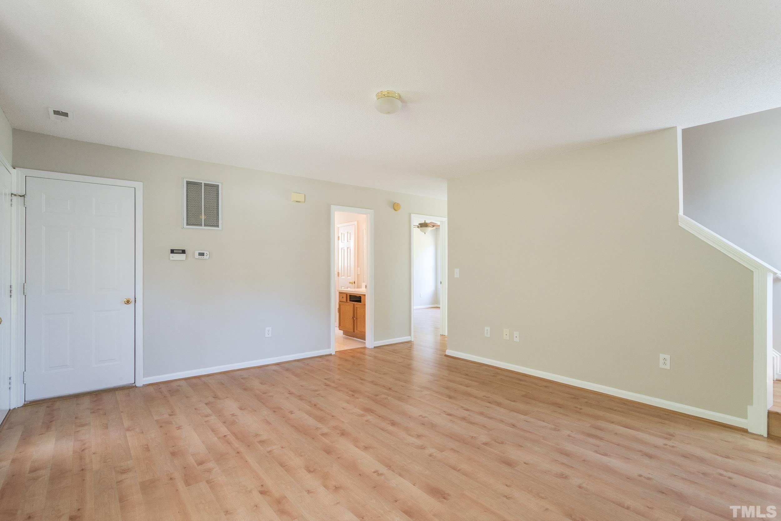 4411 Nightfall Court Durham, NC 27713 - Photo 4 of 28 a view of an empty room with wooden floor