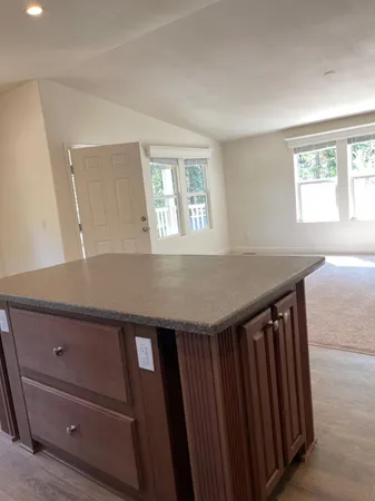 a view of hallway with a sink and a mirror