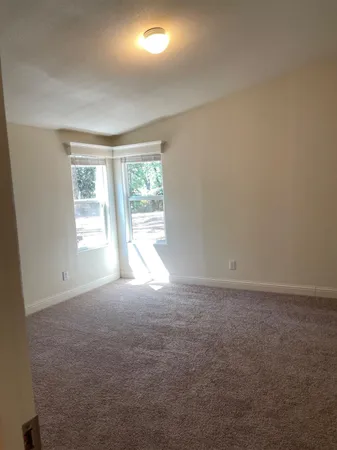 an empty room with windows and closet