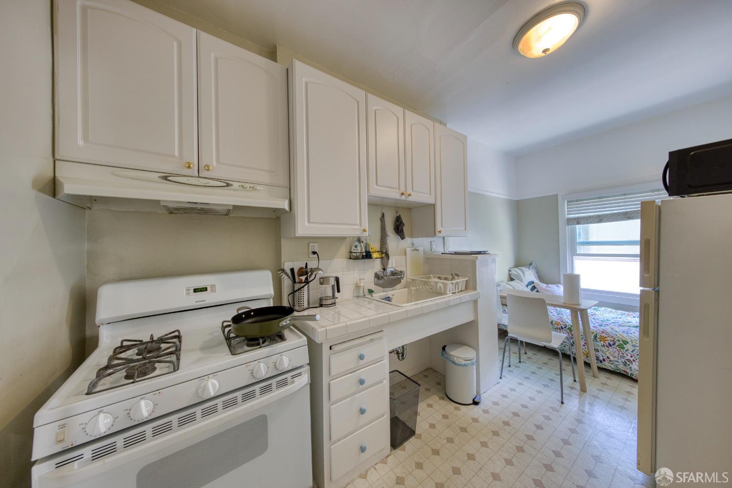 2451 Le Conte Avenue Berkeley, CA 94709 - Photo 33 of 36 a kitchen with appliances cabinets and a window