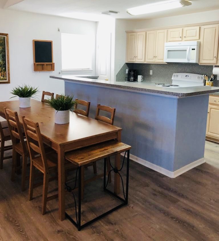 106 Coconut Road Surfside Beach, TX 77541 - Photo 15 of 25 a kitchen with granite countertop a table chairs sink and cabinets