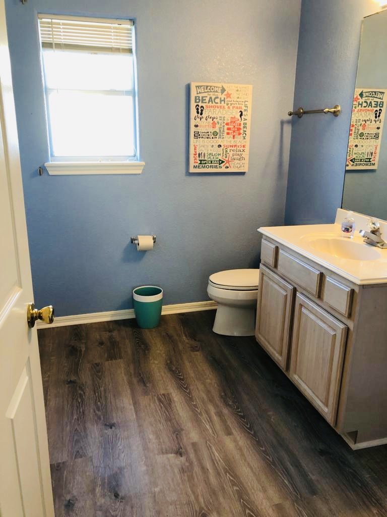106 Coconut Road Surfside Beach, TX 77541 - Photo 19 of 25 a bathroom with a toilet a sink and a window