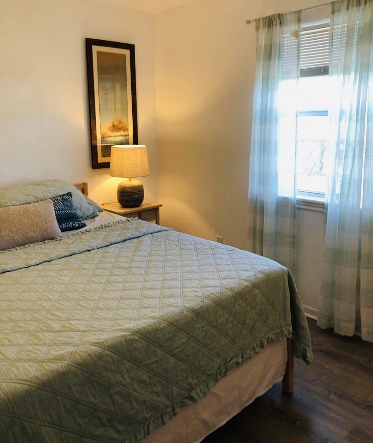 106 Coconut Road Surfside Beach, TX 77541 - Photo 23 of 25 a bedroom with a bed and wooden floor