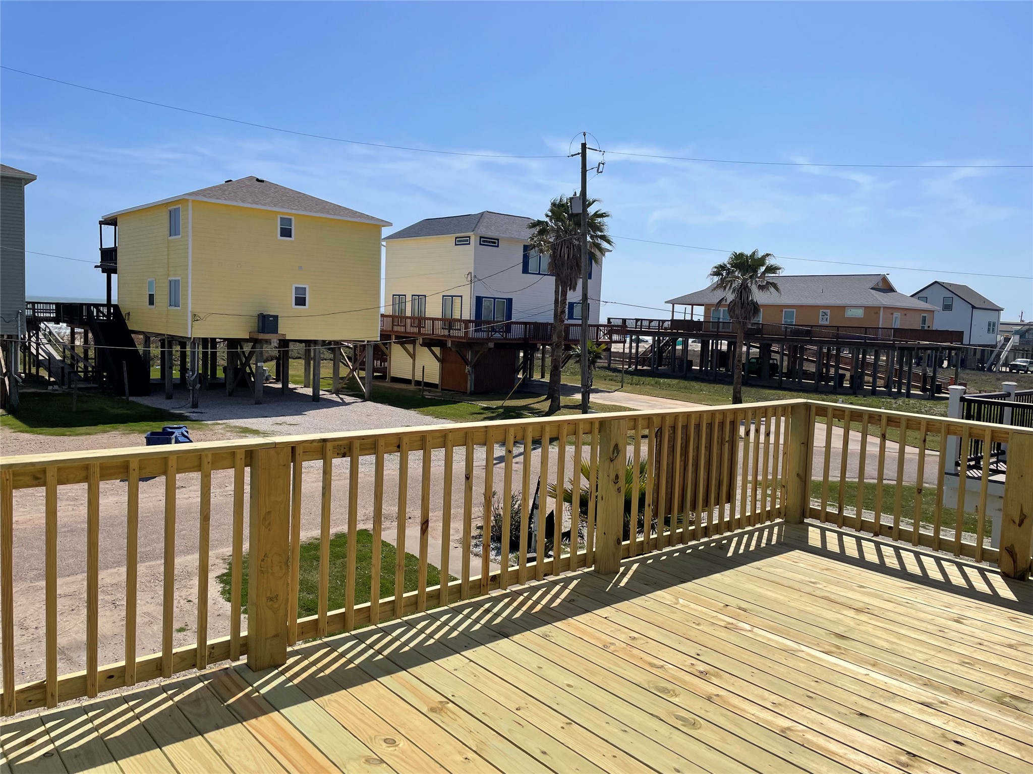 106 Coconut Road Surfside Beach, TX 77541 - Photo 4 of 25 a view of a balcony with wooden floor and fence