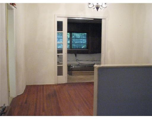 205 Southwest 21st Road Miami, FL 33129 - Photo 5 of 12 a view of a hallway with wooden floor and a cabinet