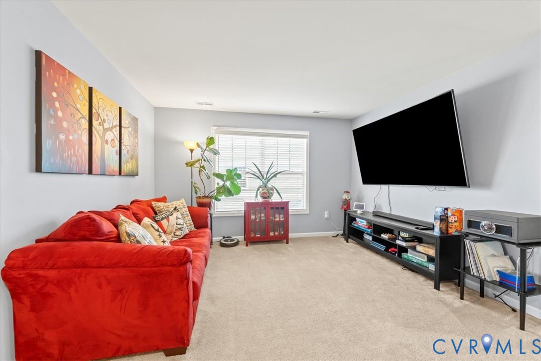 9119 Clearbrook Court Chesterfield, VA 23832 - Photo 33 of 50 a living room with furniture and a flat screen tv