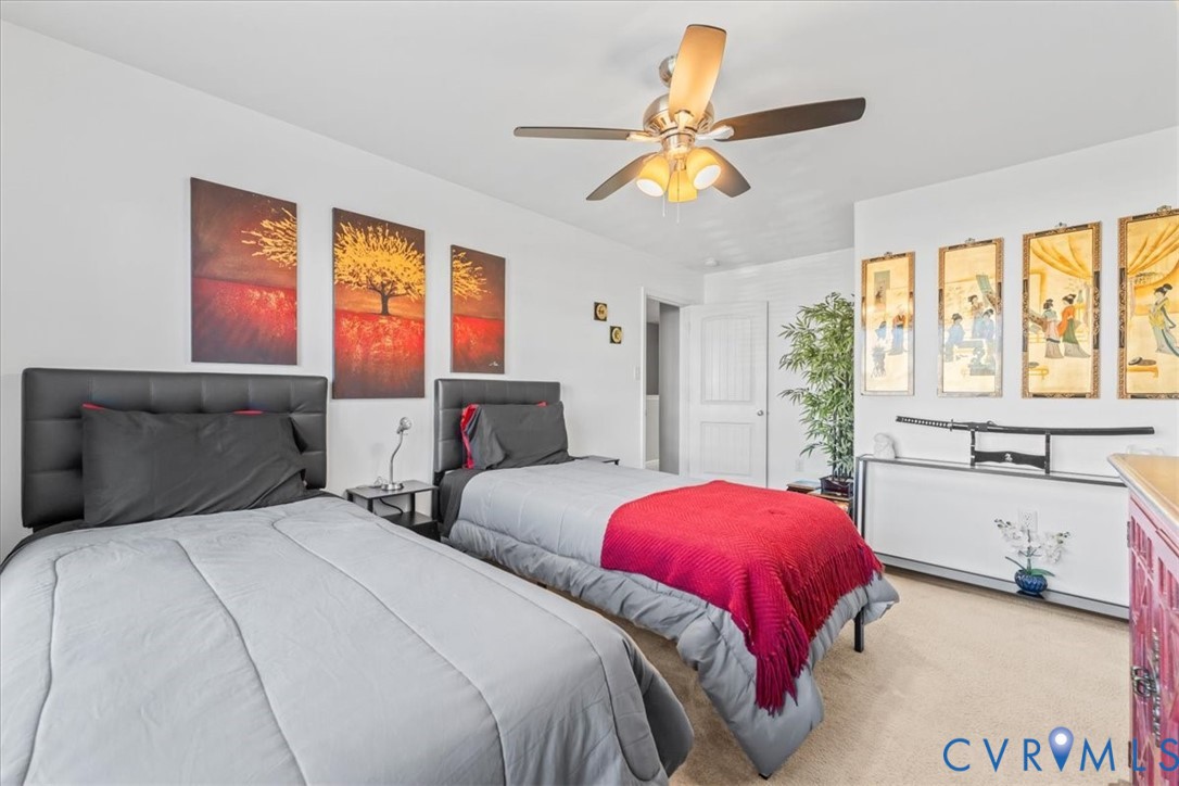 9119 Clearbrook Court Chesterfield, VA 23832 - Photo 38 of 50 a bedroom with two beds and a chandelier