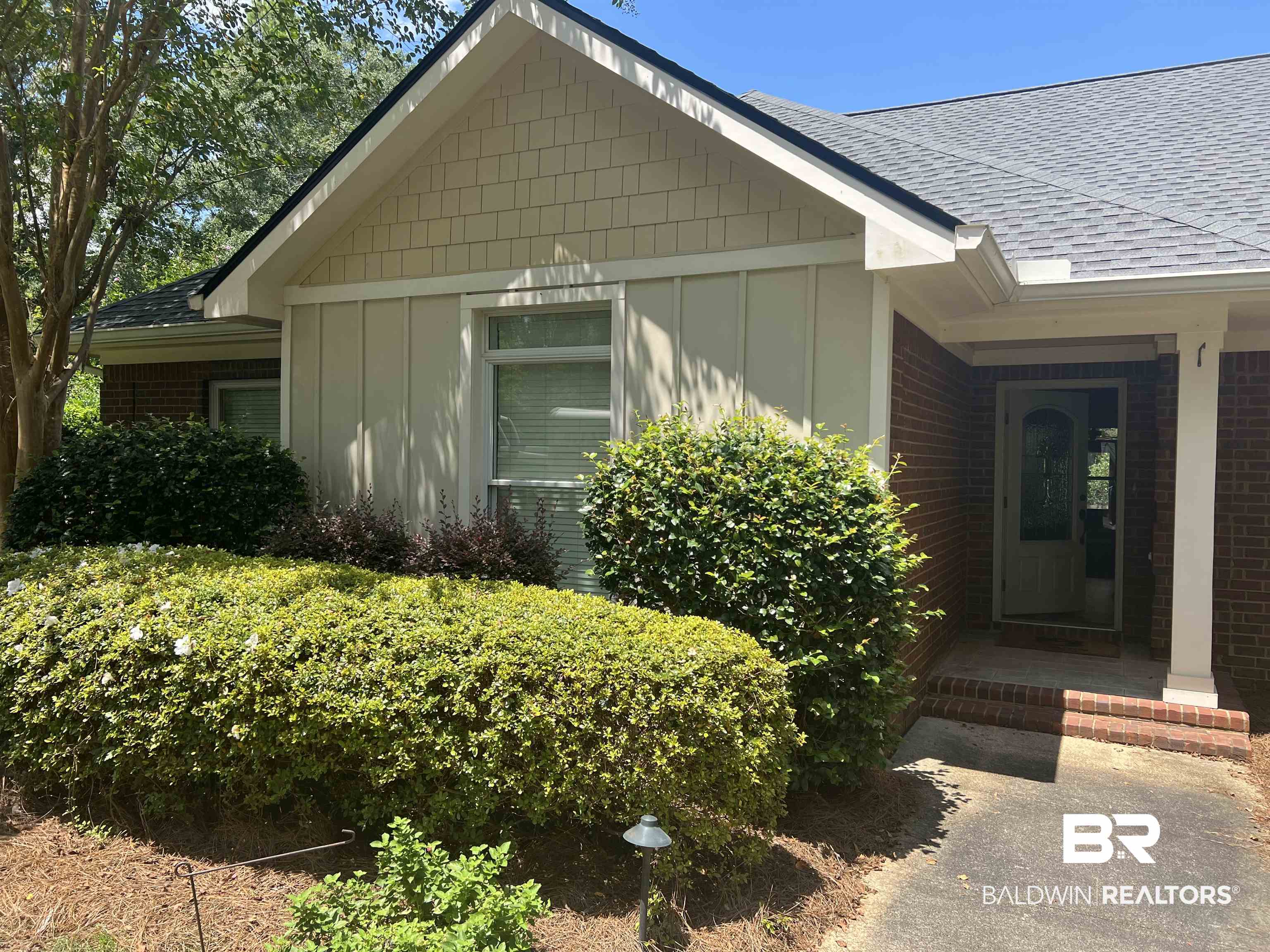 10721 Redfern Road Daphne, AL 36526 - Photo 2 of 7 Doorway to property with board and batten siding, roof with shingles, and brick siding