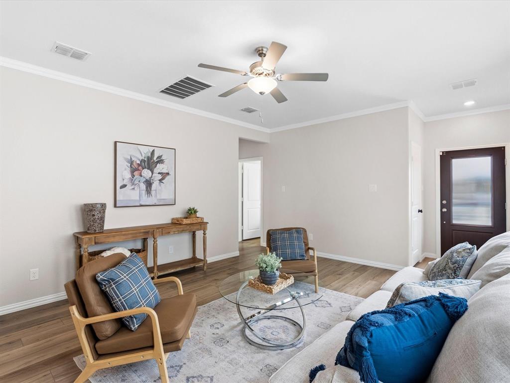 16936 Post Cedar Drive Justin, TX 76247 - Photo 5 of 30 Living area featuring wood-finish flooring, light neutral walls, and white crown molding