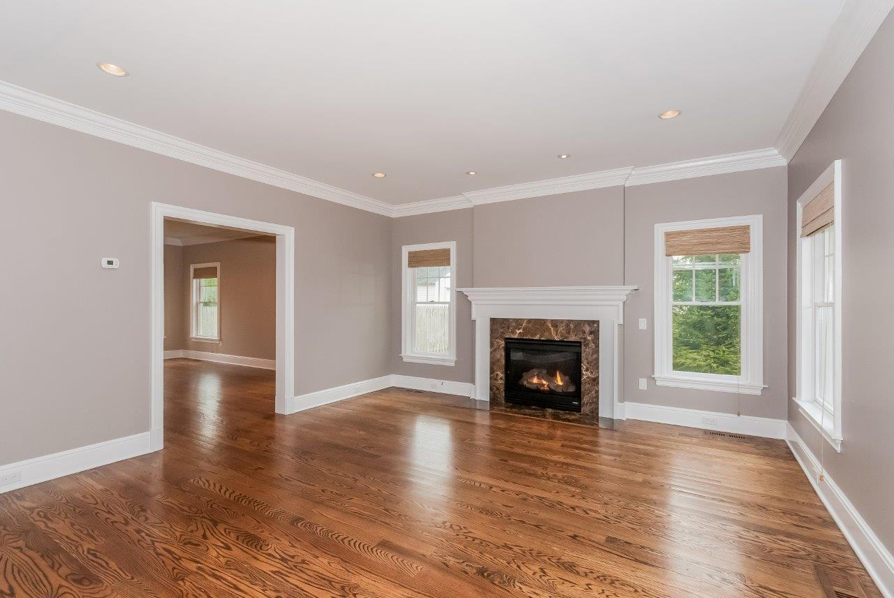44 Gower Road New Canaan, CT 06840 - Photo 12 of 53 an empty room with wooden floor fireplace and windows