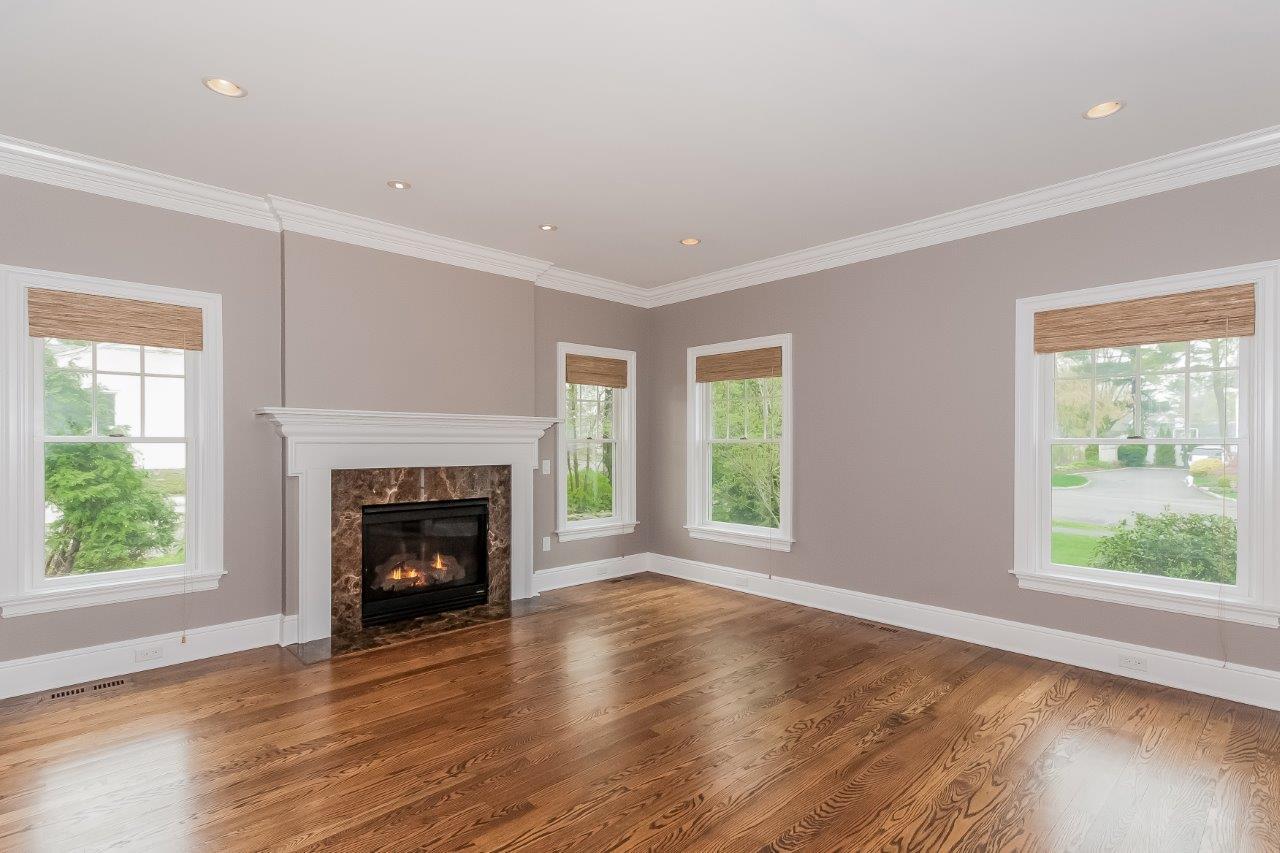 44 Gower Road New Canaan, CT 06840 - Photo 14 of 53 an empty room with wooden floor windows and a fireplace