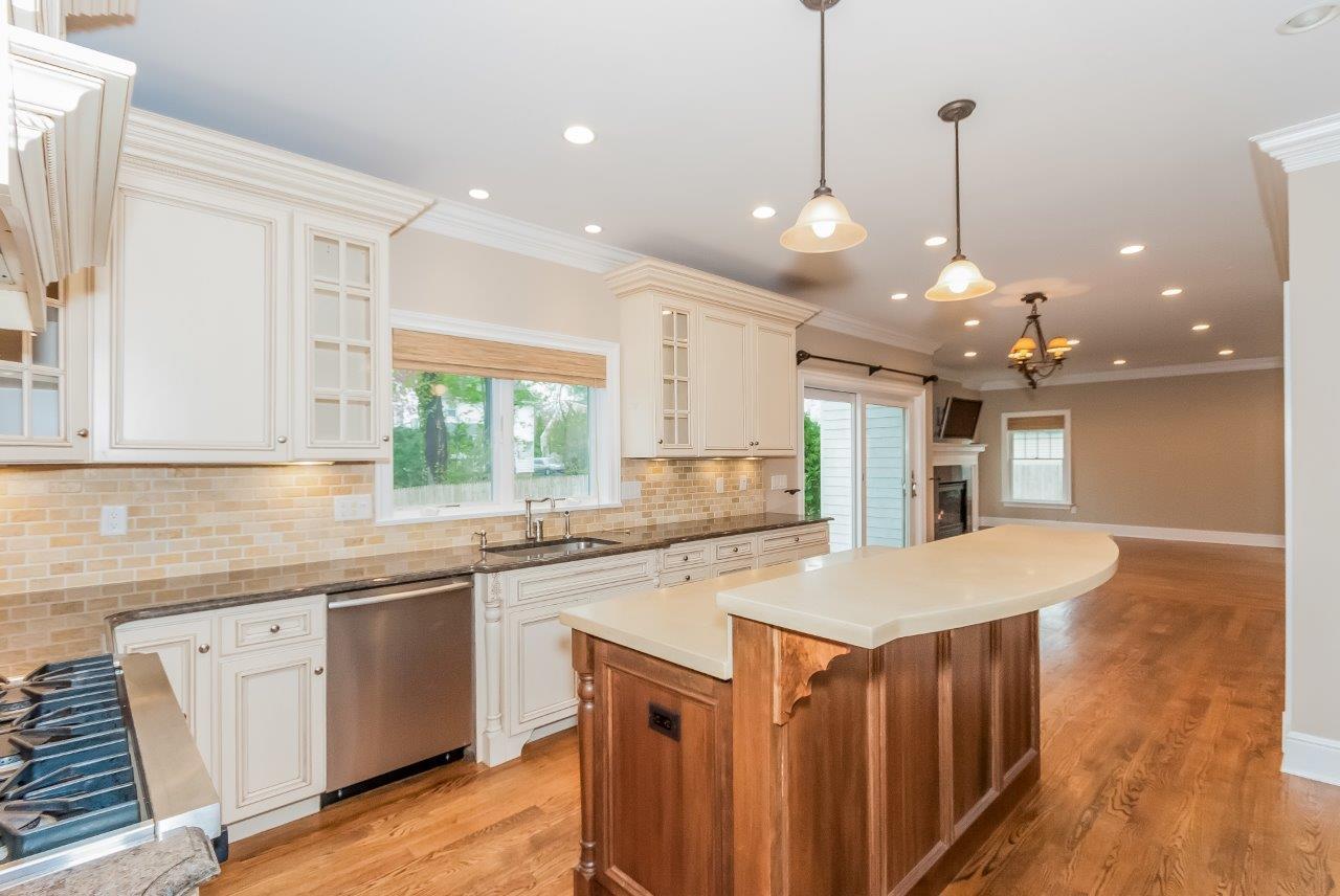 44 Gower Road New Canaan, CT 06840 - Photo 19 of 53 a kitchen with a stove a sink a center island and cabinets