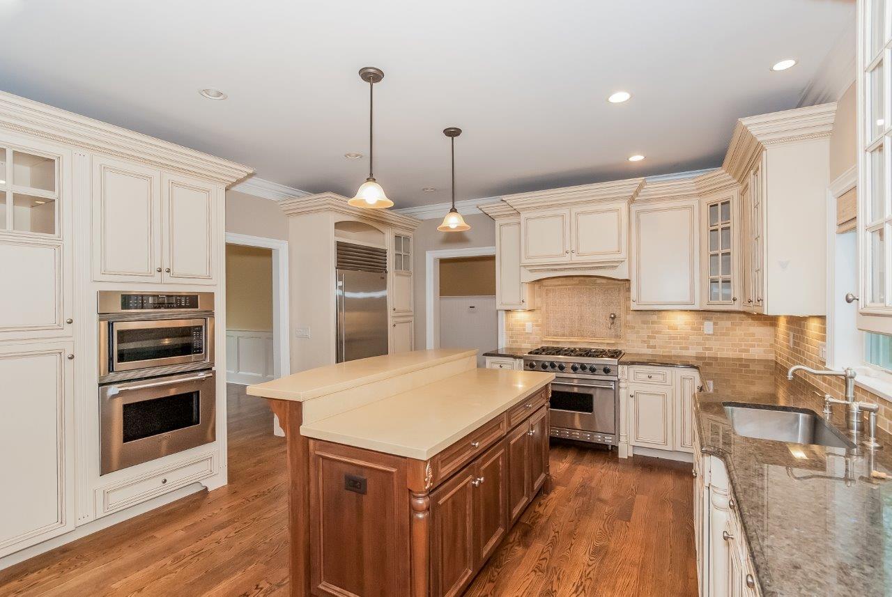 44 Gower Road New Canaan, CT 06840 - Photo 20 of 53 a kitchen with stainless steel appliances granite countertop a stove top oven a sink and a refrigerator