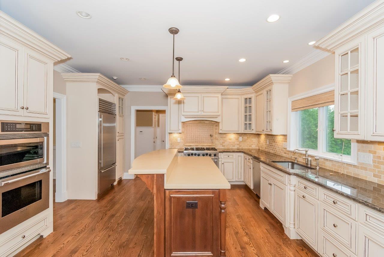 44 Gower Road New Canaan, CT 06840 - Photo 21 of 53 a large kitchen with stainless steel appliances granite countertop a stove a sink and a refrigerator