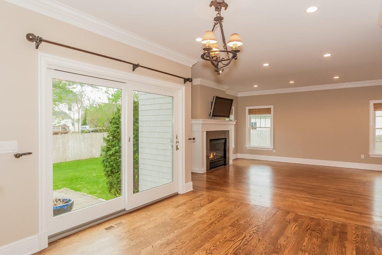 44 Gower Road New Canaan, CT 06840 - Photo 25 of 53 a view of a livingroom with a fireplace wooden floor and windows