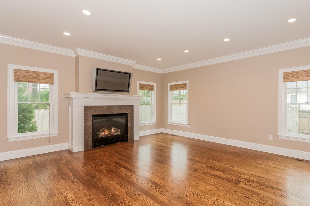 44 Gower Road New Canaan, CT 06840 - Photo 27 of 53 a living room with a fireplace with wooden floor