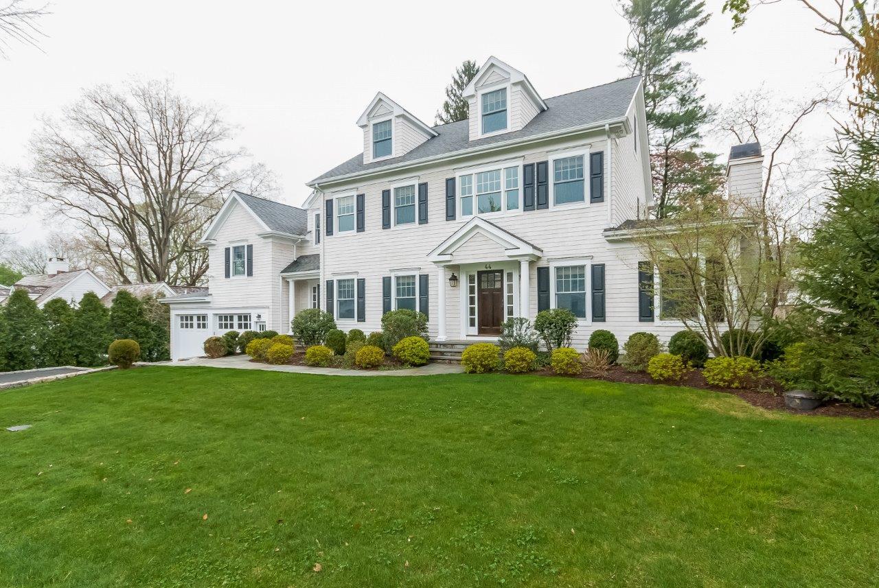 44 Gower Road New Canaan, CT 06840 - Photo 3 of 53 a front view of a house with a garden and trees