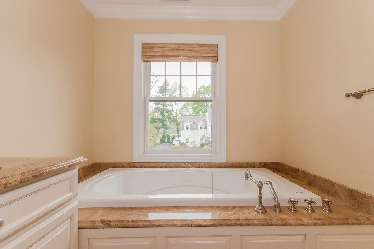 44 Gower Road New Canaan, CT 06840 - Photo 38 of 53 a bathroom with a bathtub and a window