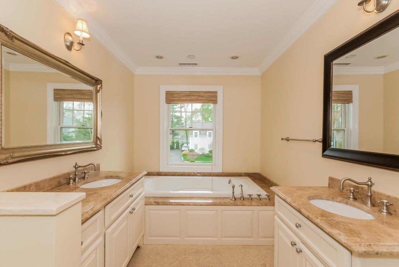 44 Gower Road New Canaan, CT 06840 - Photo 39 of 53 a bathroom with a granite countertop sink and a bathtub